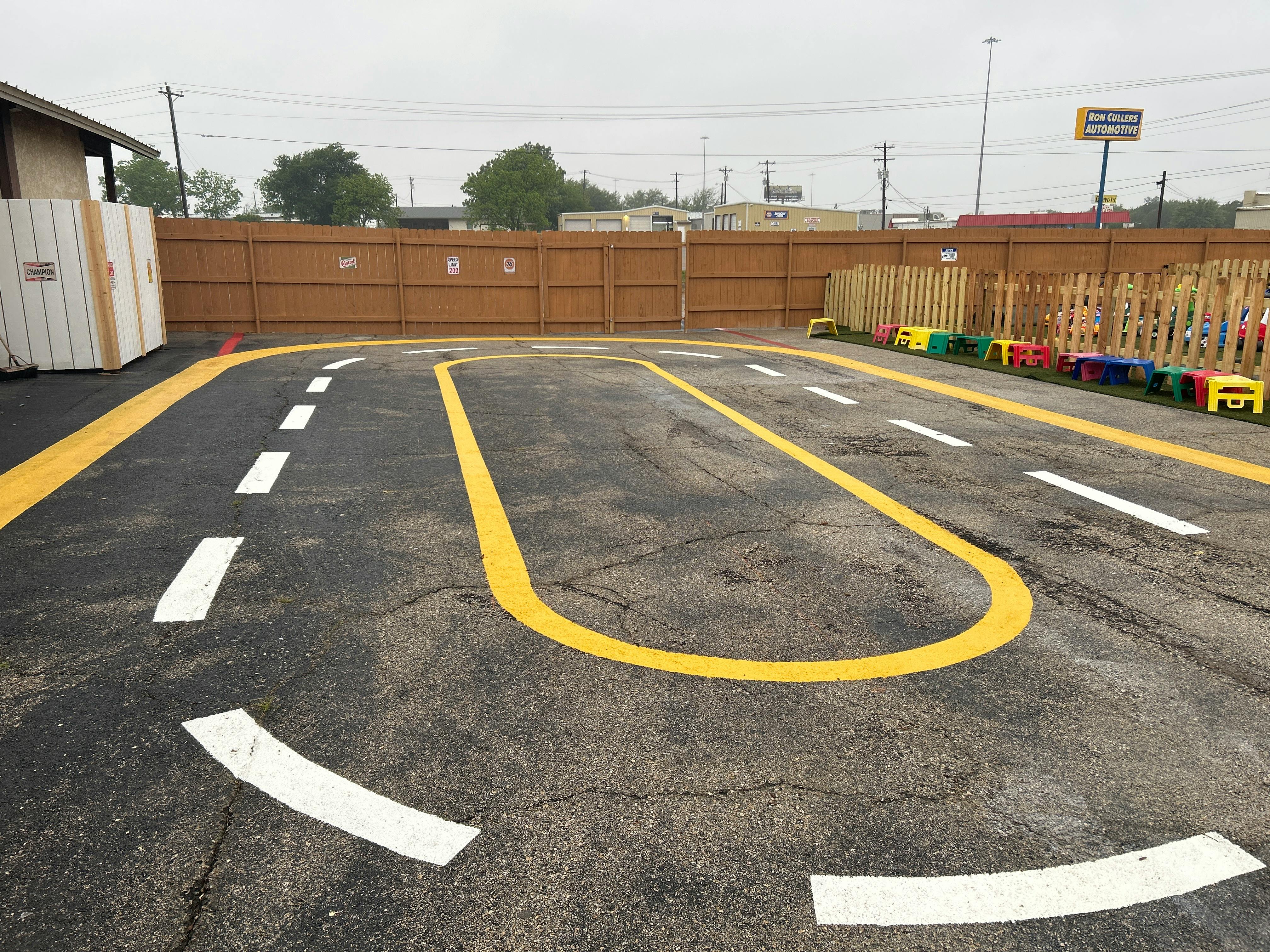 Paved area with yellow and white lines painted on the ground