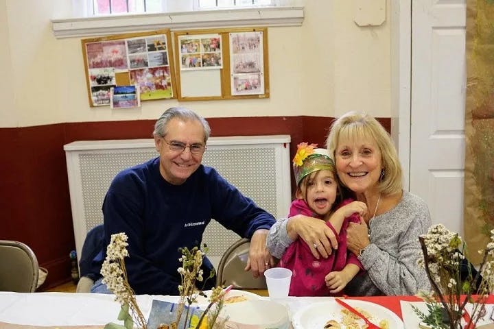 Man, woman, and child sitting at a table