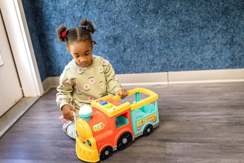 Child playing with a toy train