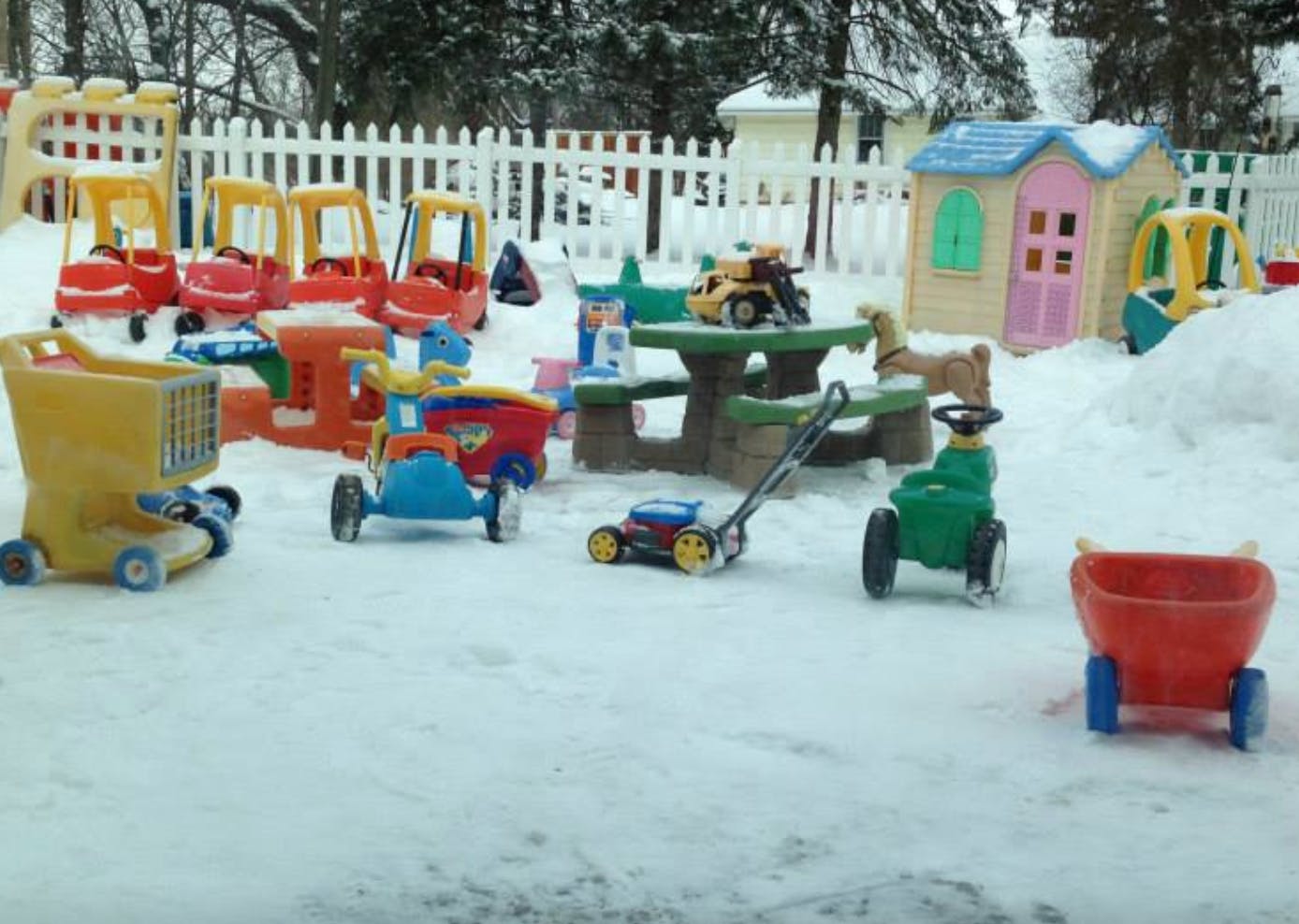 Children's toys in a snowy yard