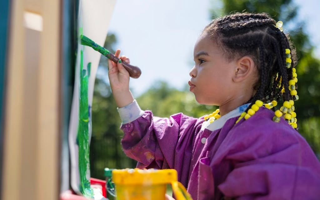 Child painting with a brush