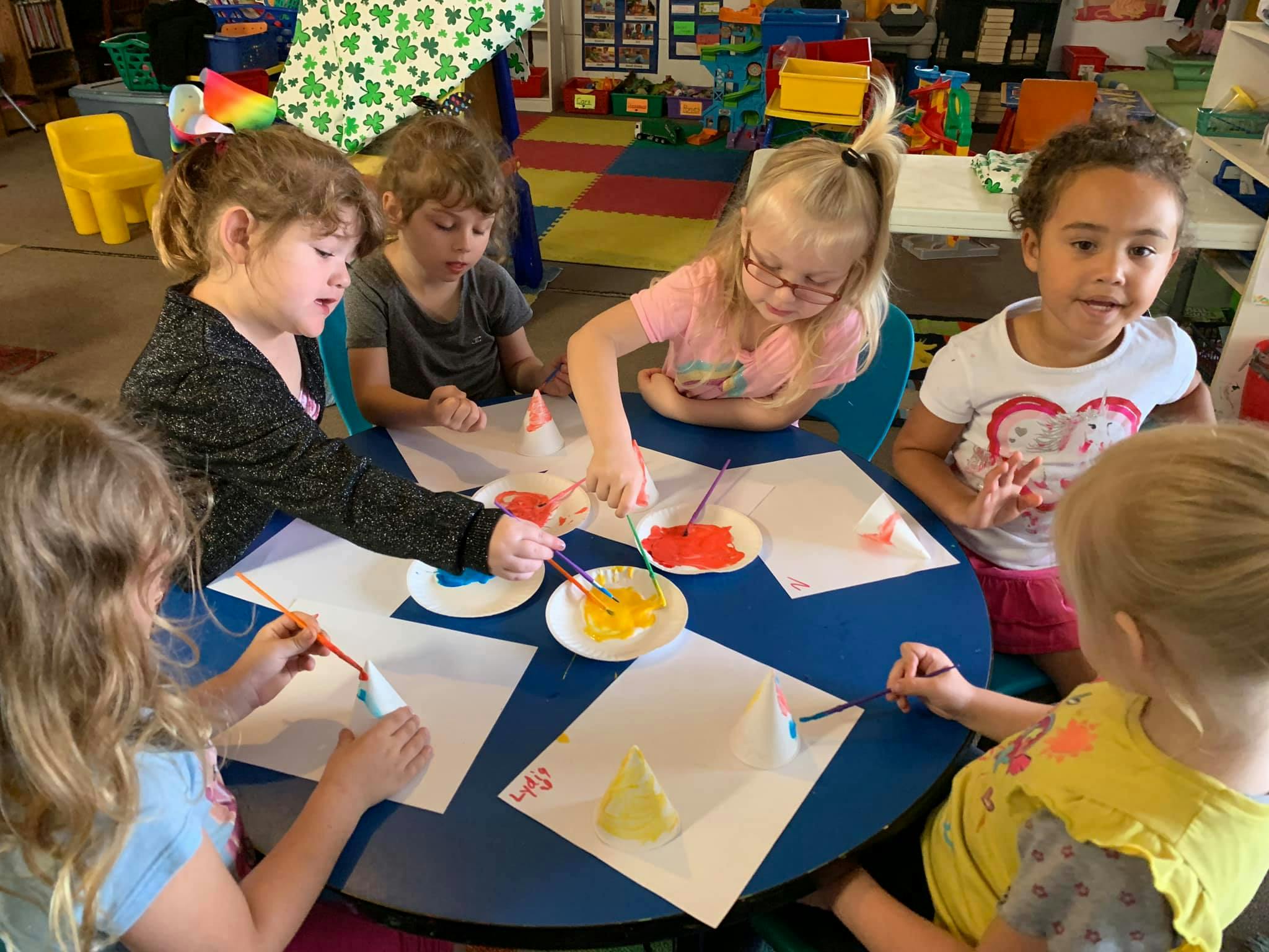 Children painting at a table