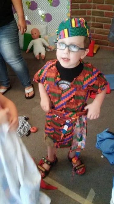 Child in glasses and colorful patterned clothing
