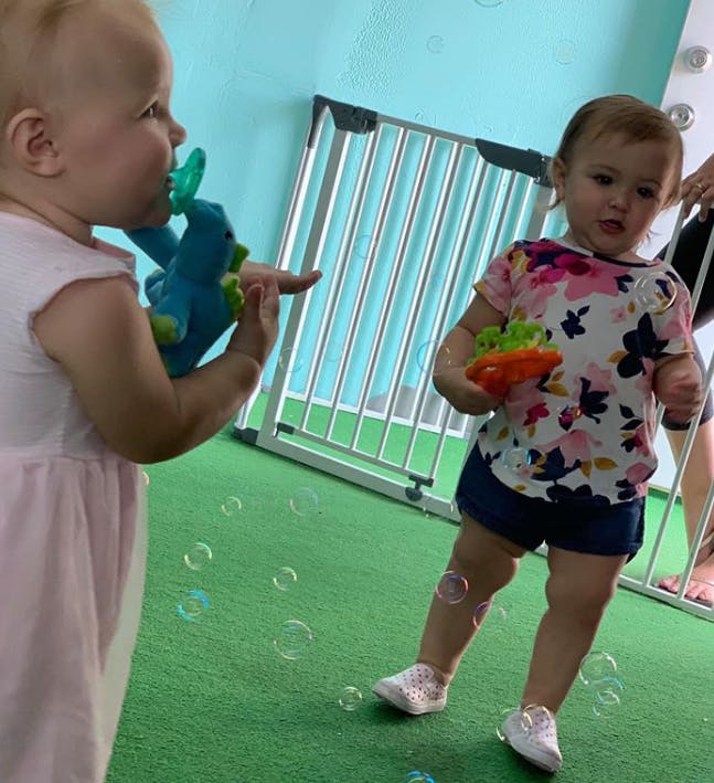 Two children playing with toys and bubbles
