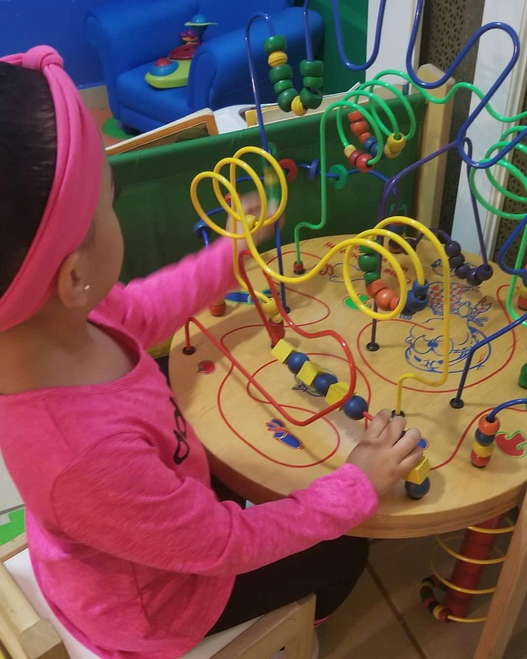 Child playing with a bead maze toy