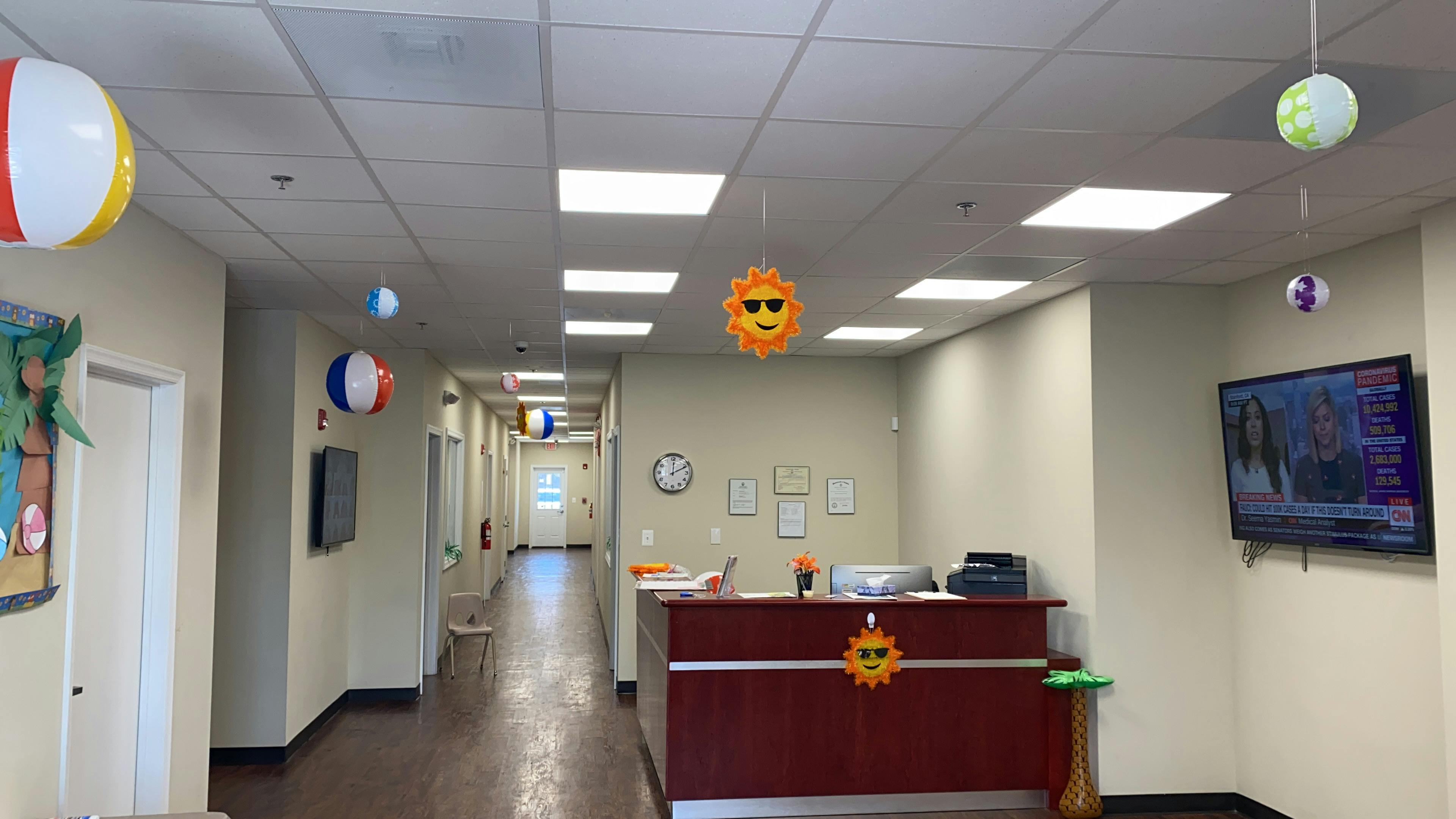 Hallway with a reception desk and beach ball decorations