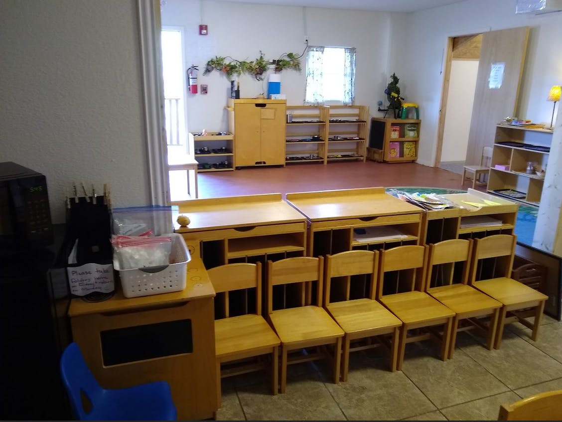 Classroom with small wooden tables and chairs