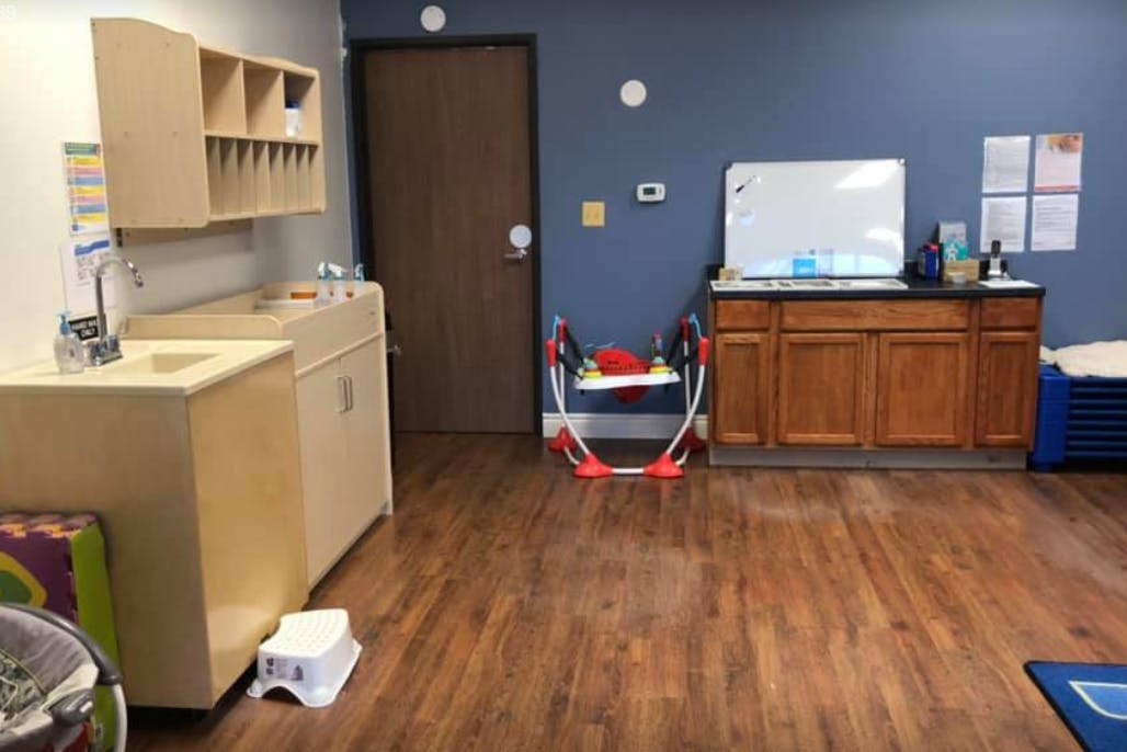 Classroom with sink, cabinets, and whiteboard