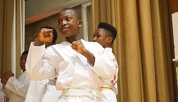 Two teens in martial arts uniforms