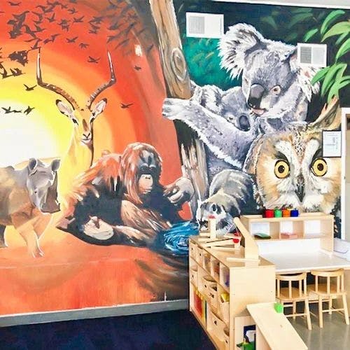 Mural of various animals including an orangutan, deer, koala, and owl