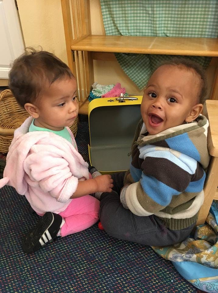 Two children sitting on the floor