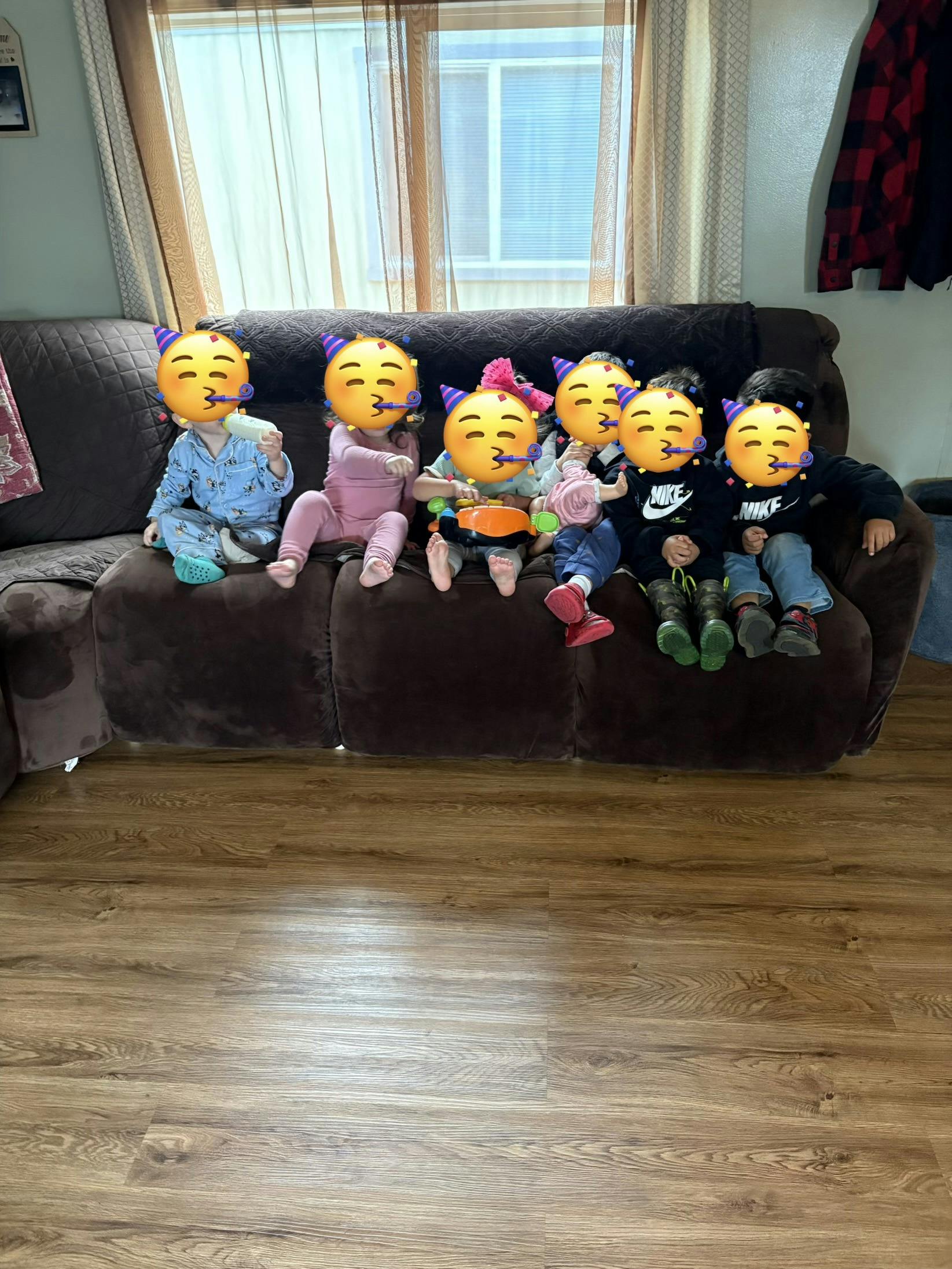 Group of children sitting together on a couch