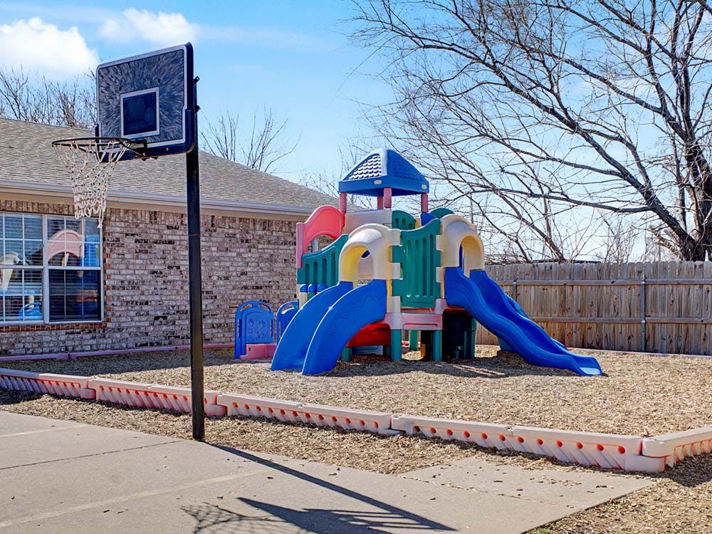 Basketball hoop and children's playground with slides
