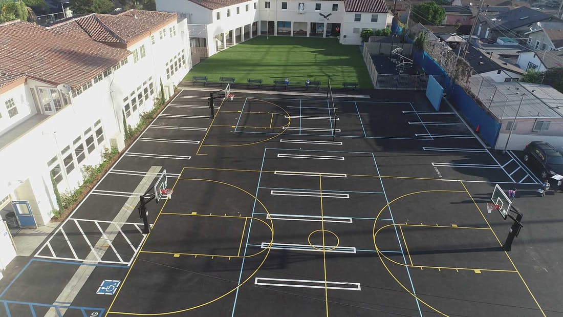 Aerial view of a school's empty basketball court and playground