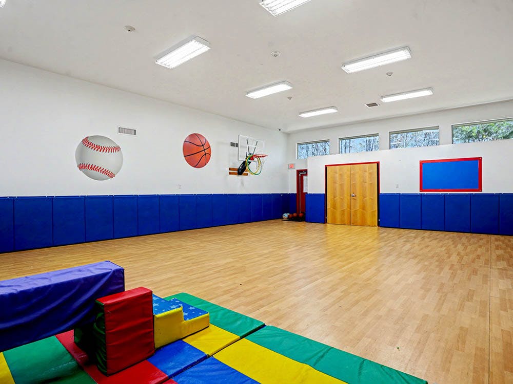 Indoor play area with colorful soft blocks and blue wall padding
