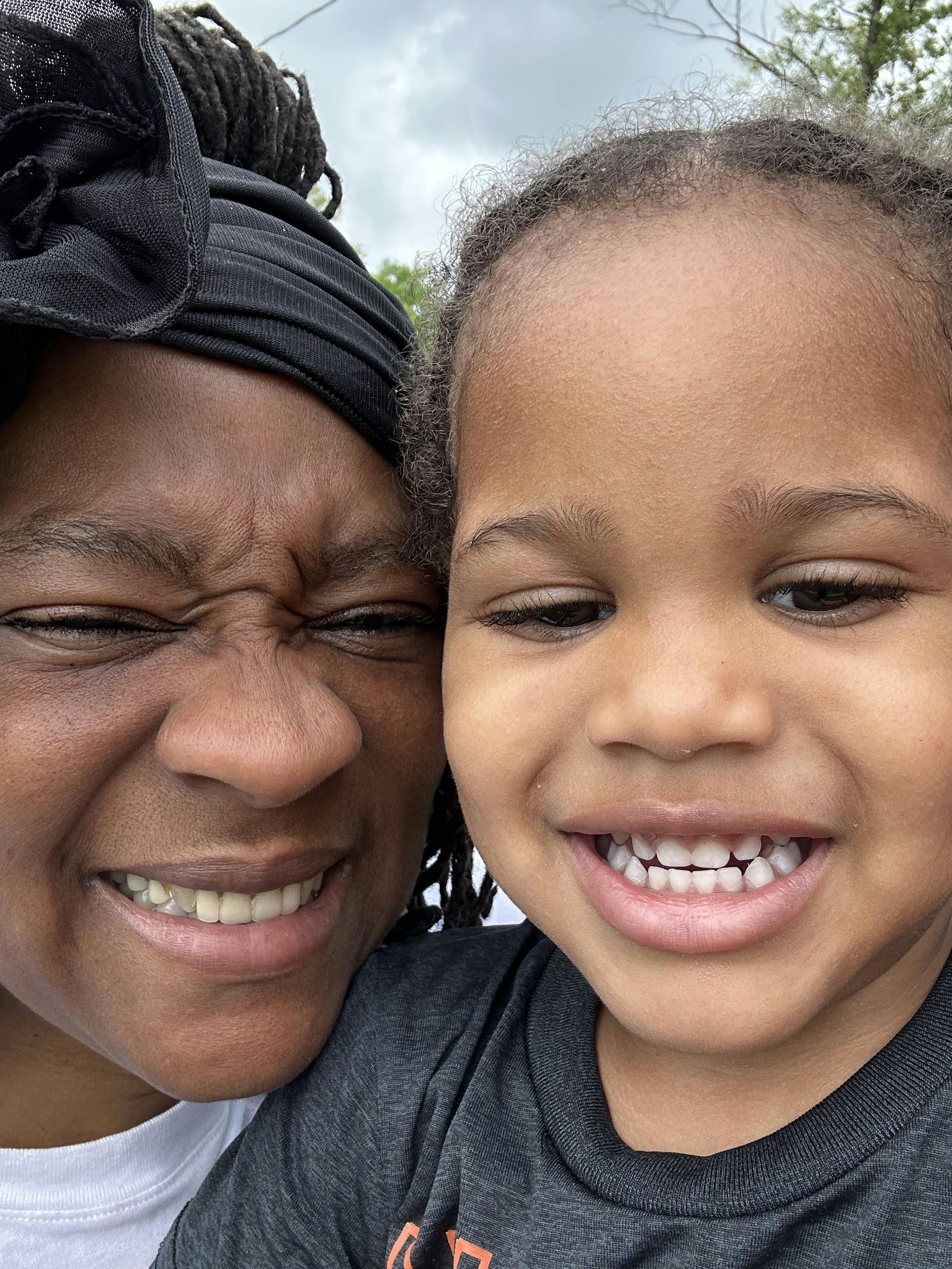 Close-up of a person and a child posing for a selfie