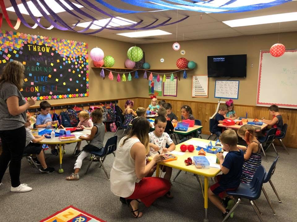 Adults and children in a classroom setting