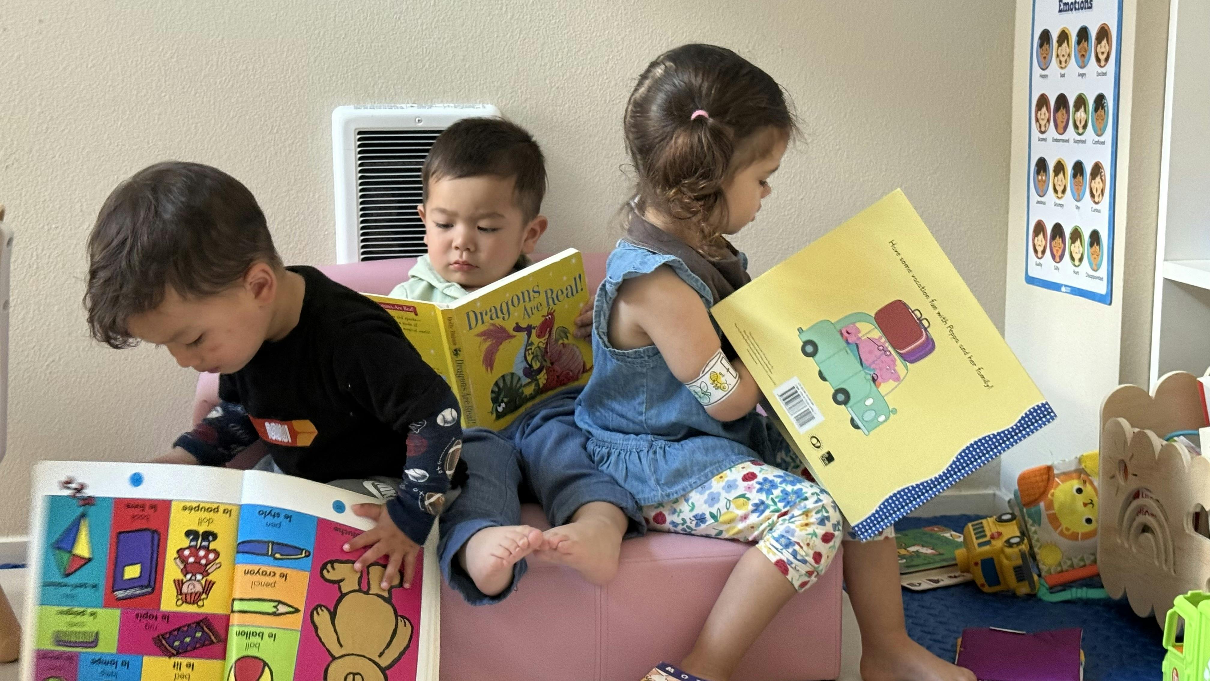 Three children reading books