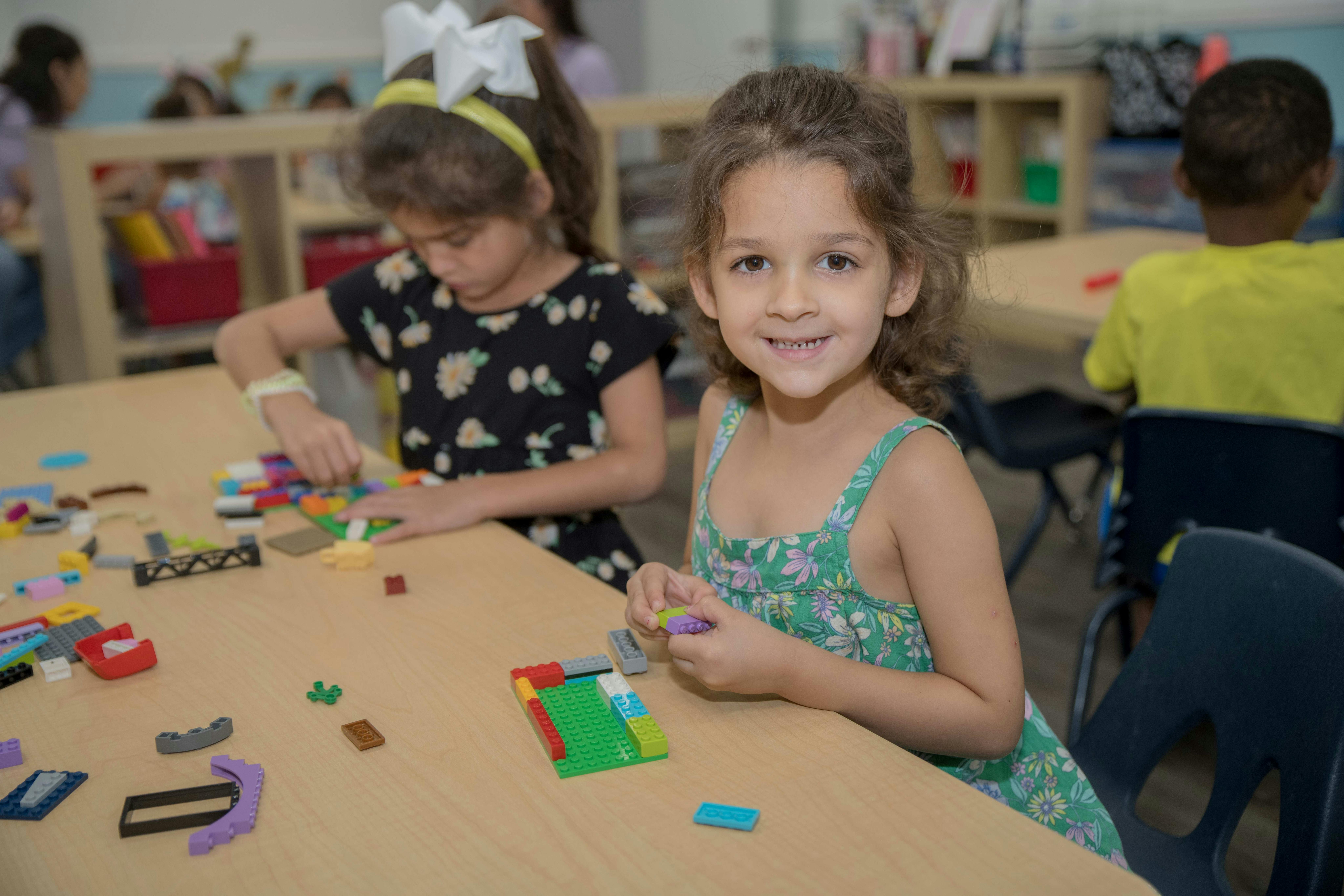 Child playing with building blocks at a table