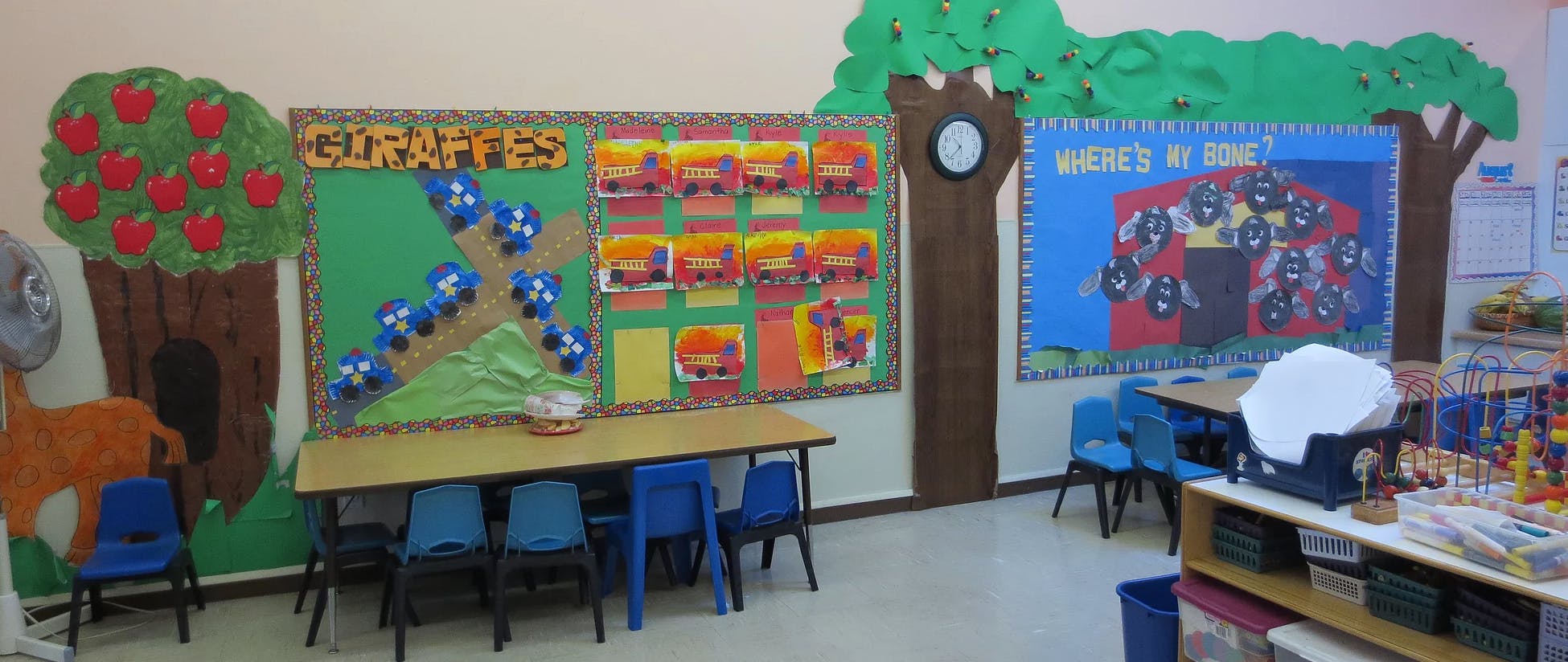 Classroom with tables, chairs, and decorated walls