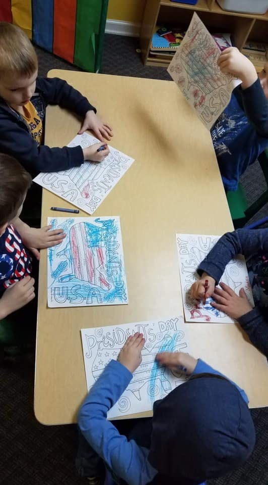Children coloring at a table