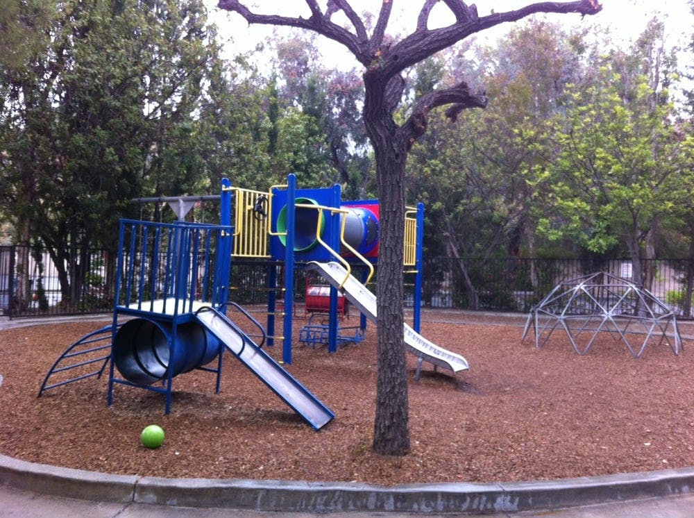 Playground with slides, climbing structure, and geodesic dome