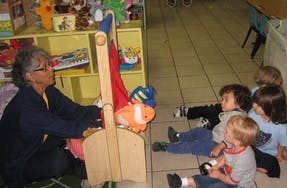Person using a puppet theater for children
