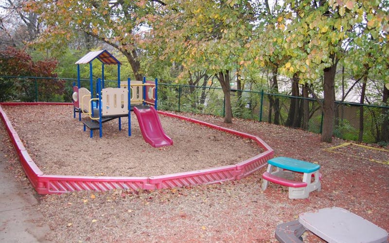 Playground equipment with a slide in a wood chip area