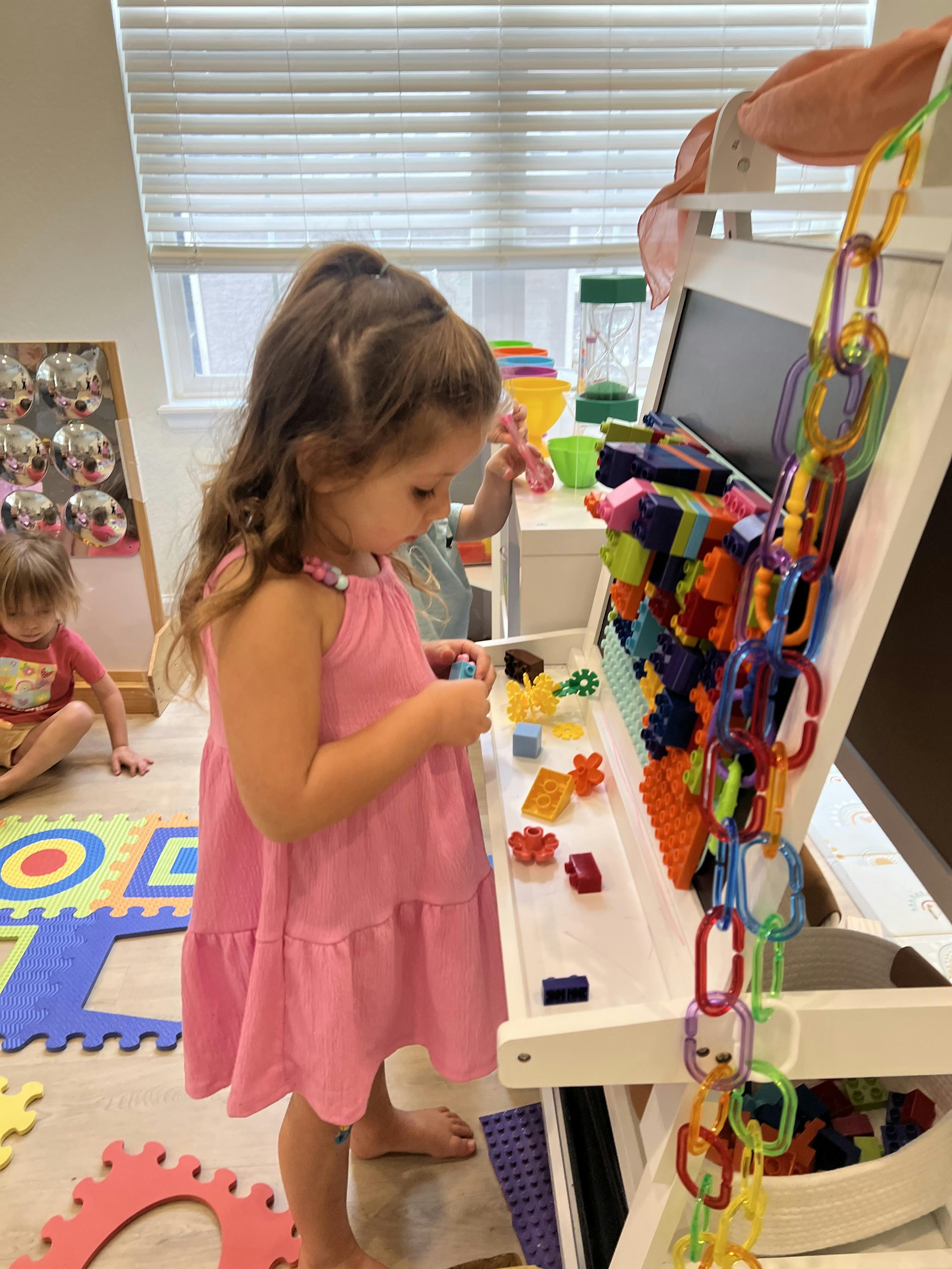 Child playing with colorful building blocks