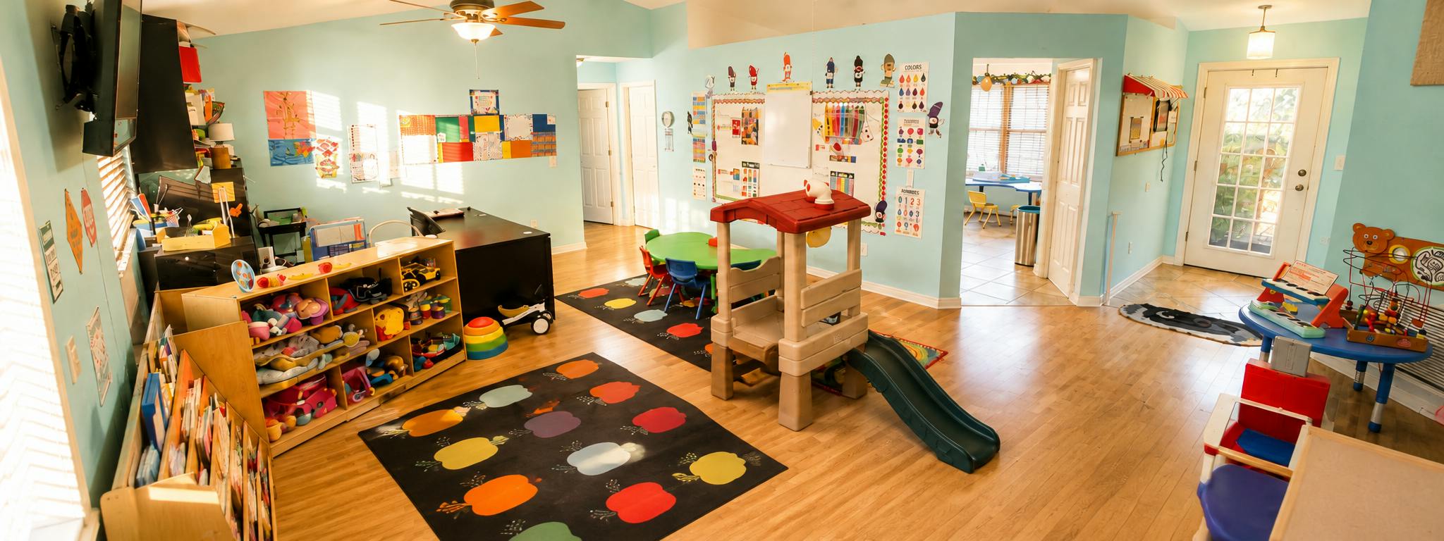 Playroom with children toys furniture and educational posters on the walls