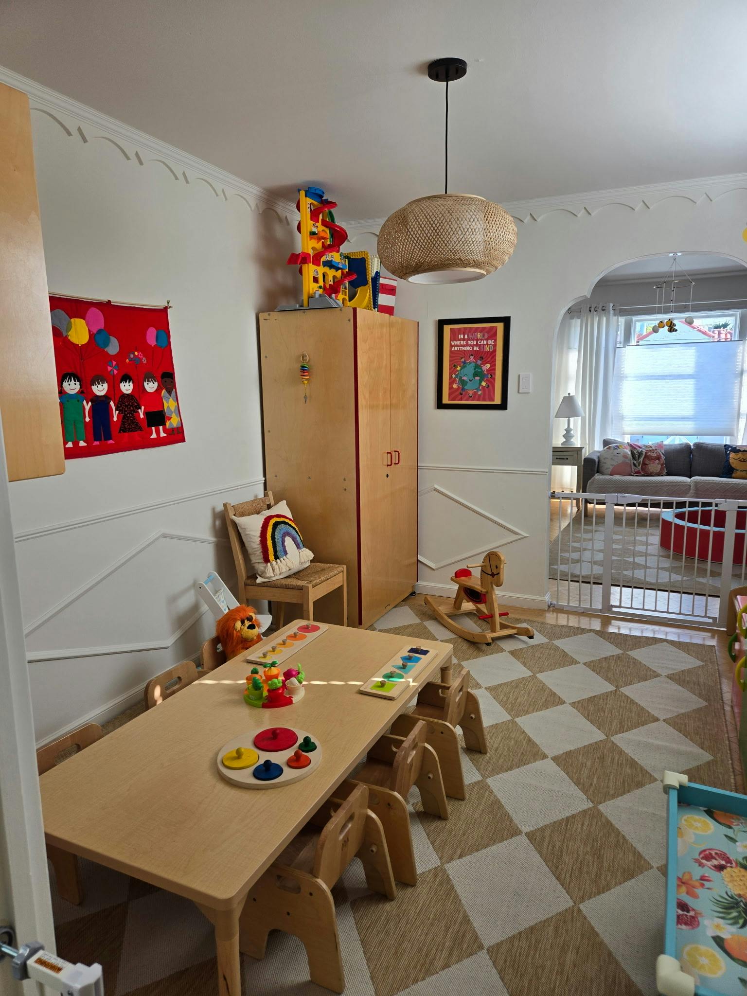 Children's play area with small table and chairs, toys, and a rocking horse