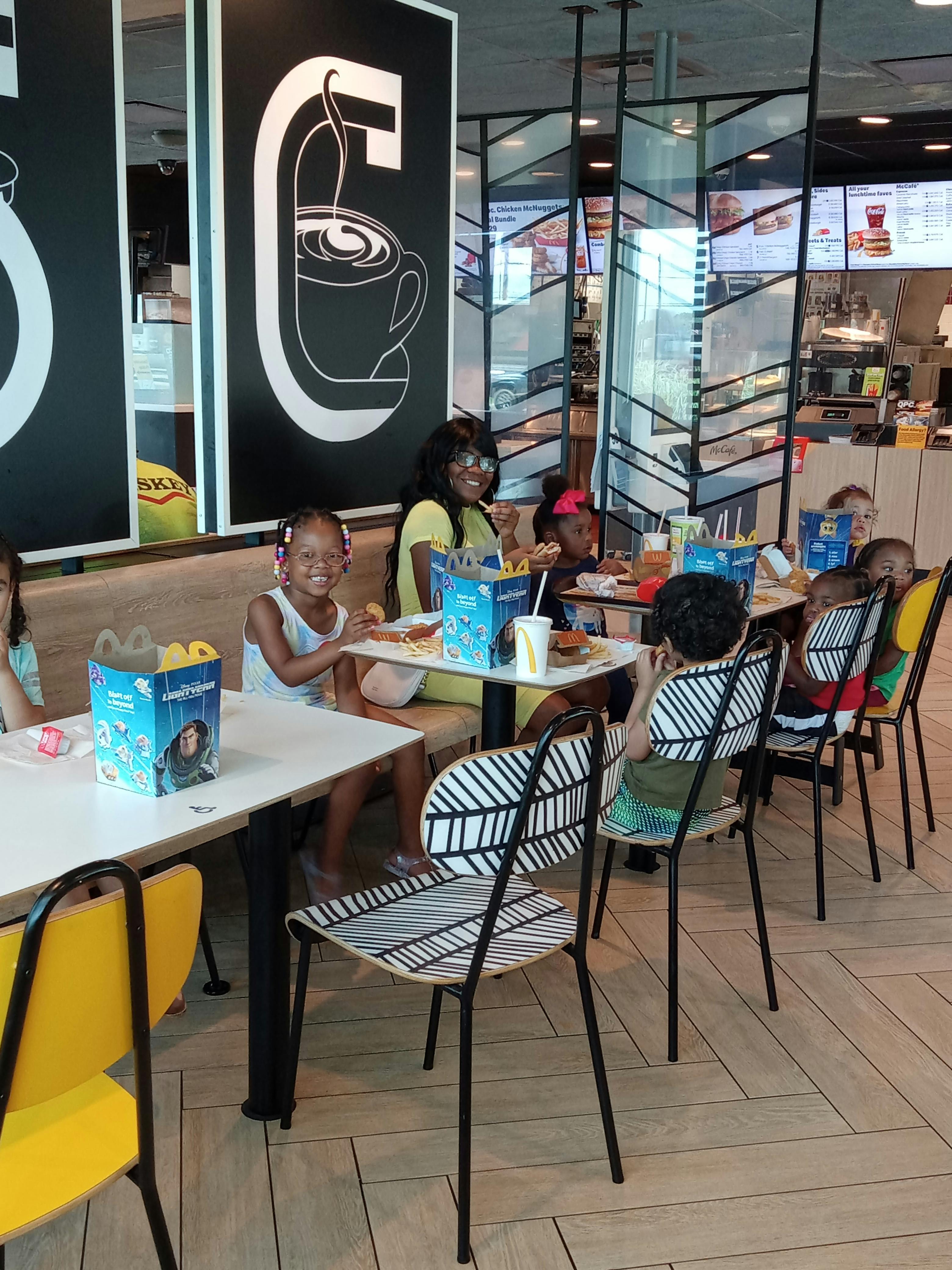 Adult and children eating at tables in a restaurant