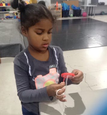 Child holding a small red object