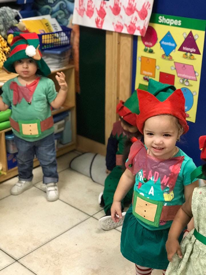 Children in elf costumes in a classroom