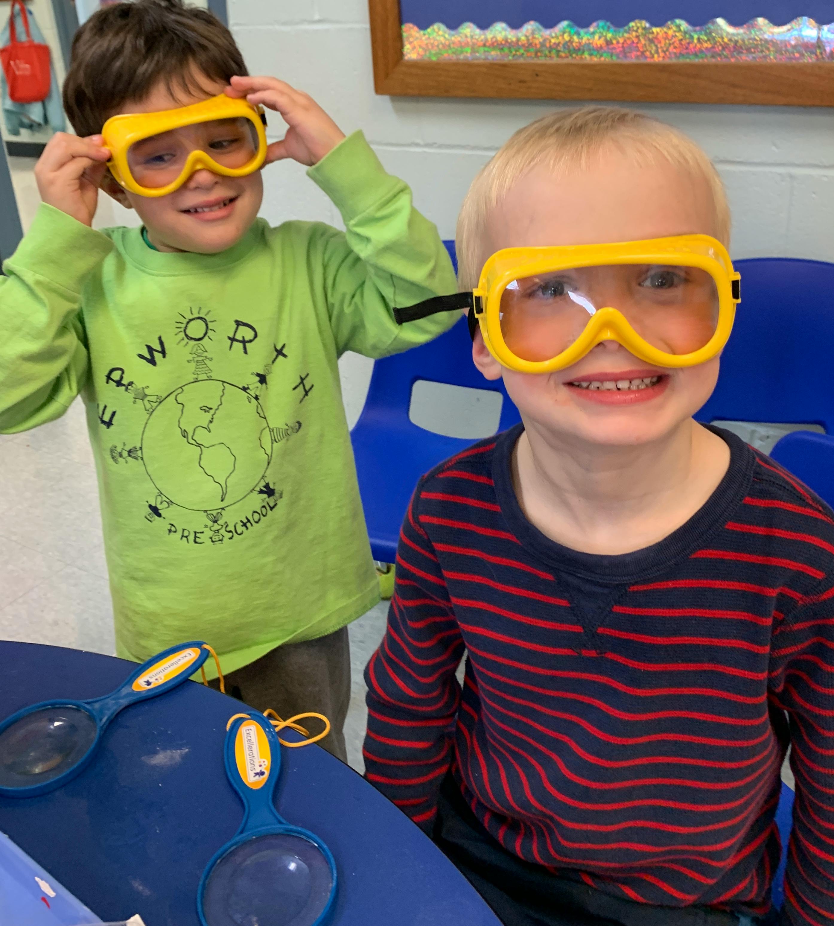 Two children wearing yellow safety goggles