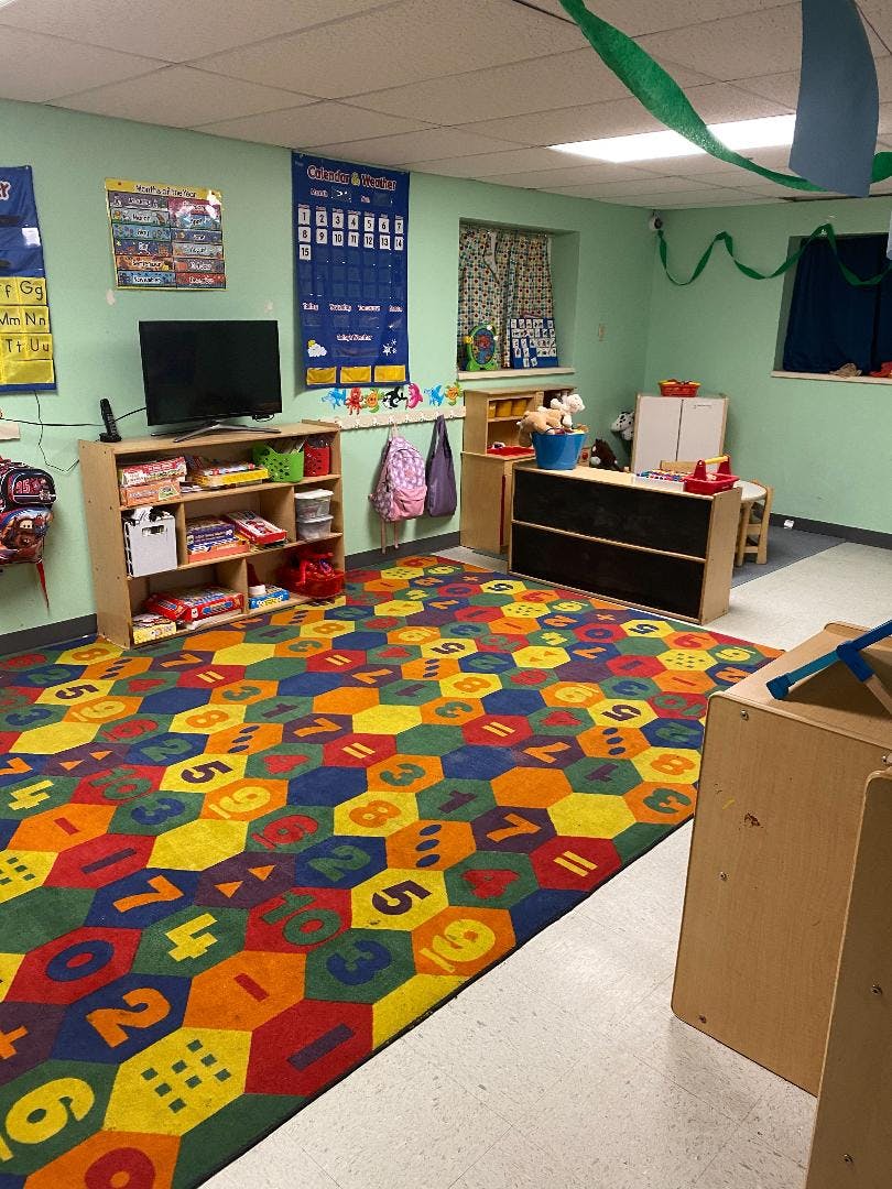 Classroom with colorful hexagonal rug with numbers and letters