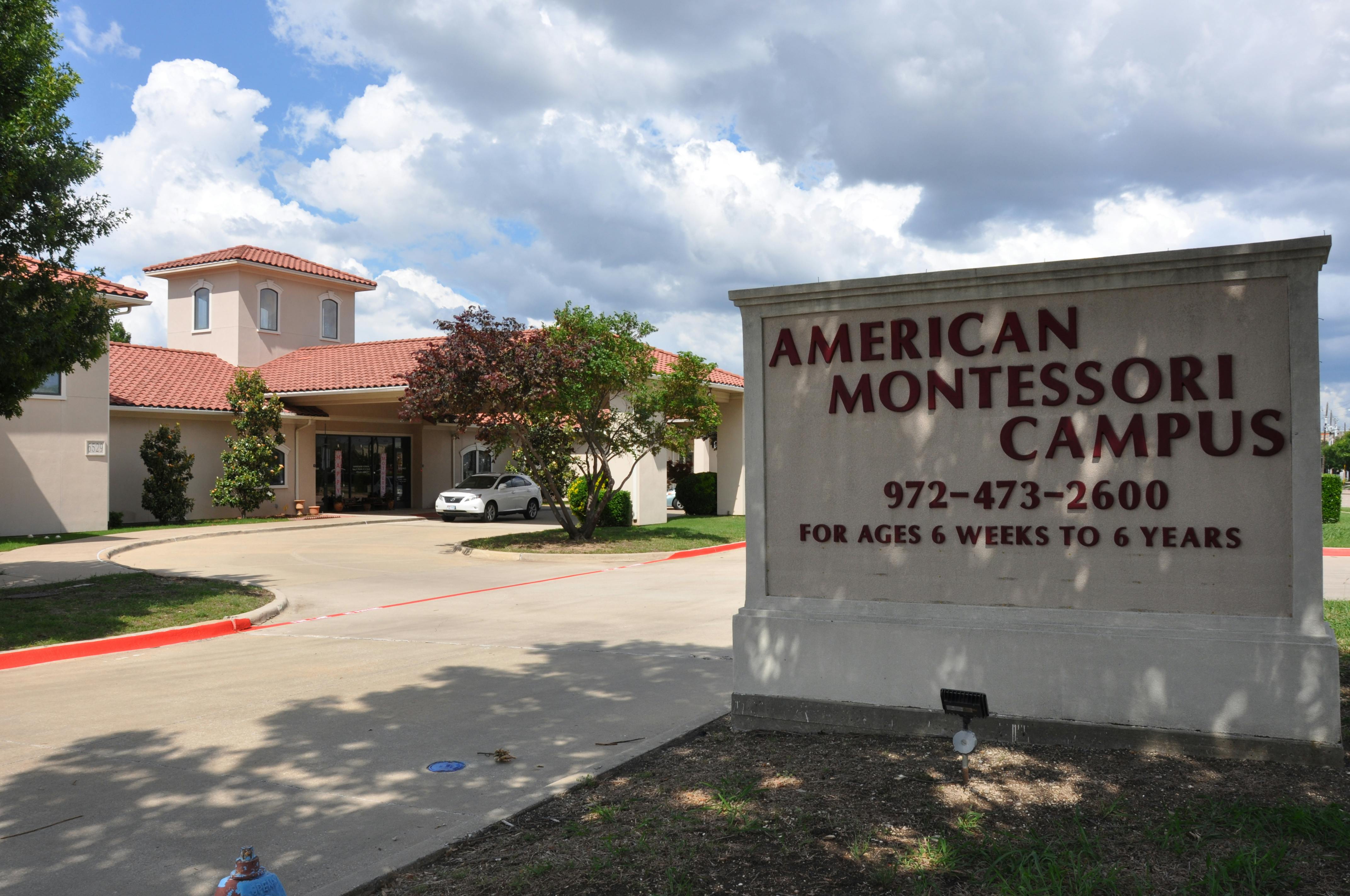 Sign for American Montessori Campus with building and driveway in background