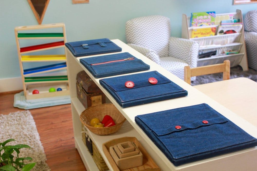 Montessori classroom with dressing frames and a wooden ball run