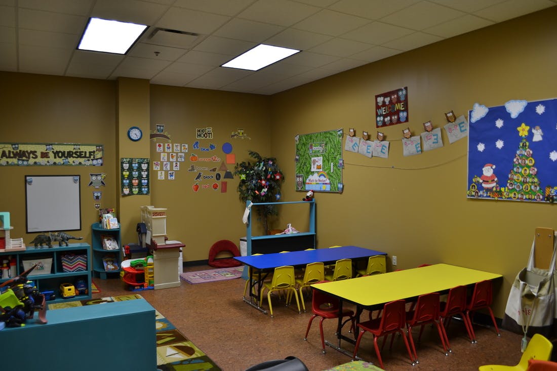 Classroom with small tables and chairs, decorated walls