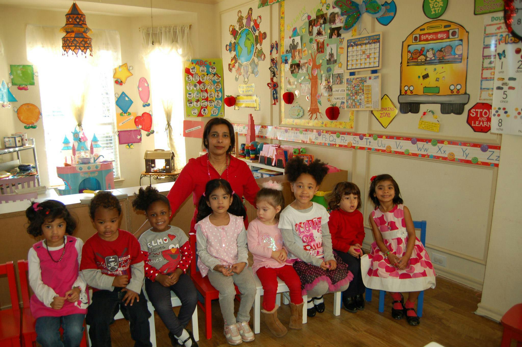 Person and multiple children sitting in a classroom