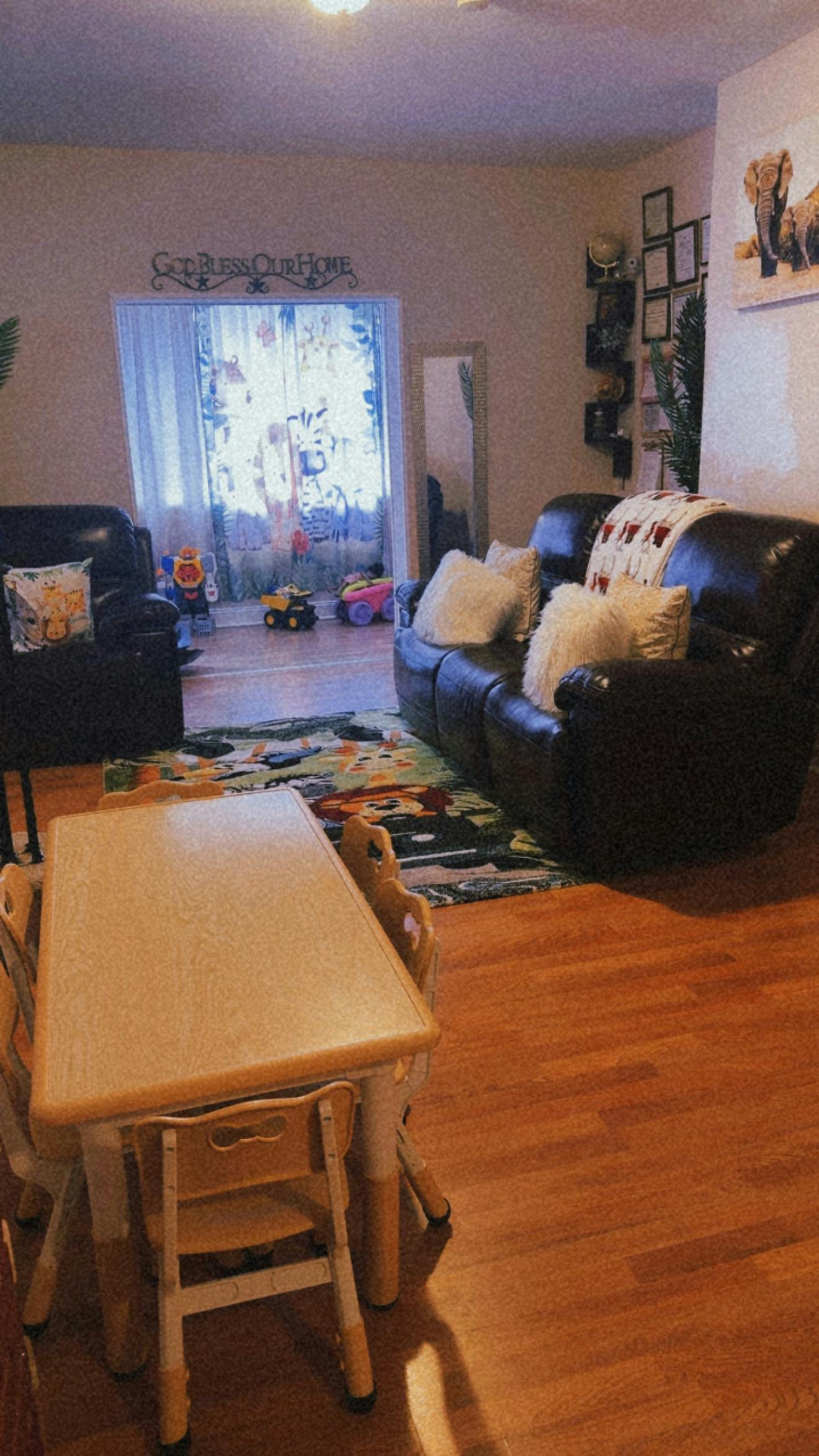 Living room featuring a small table with chairs and leather sofas