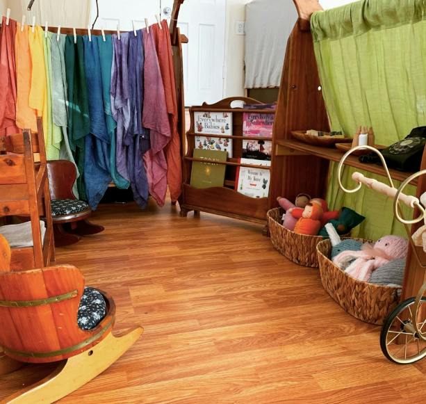 Children's play area with colorful fabrics, books, and toys