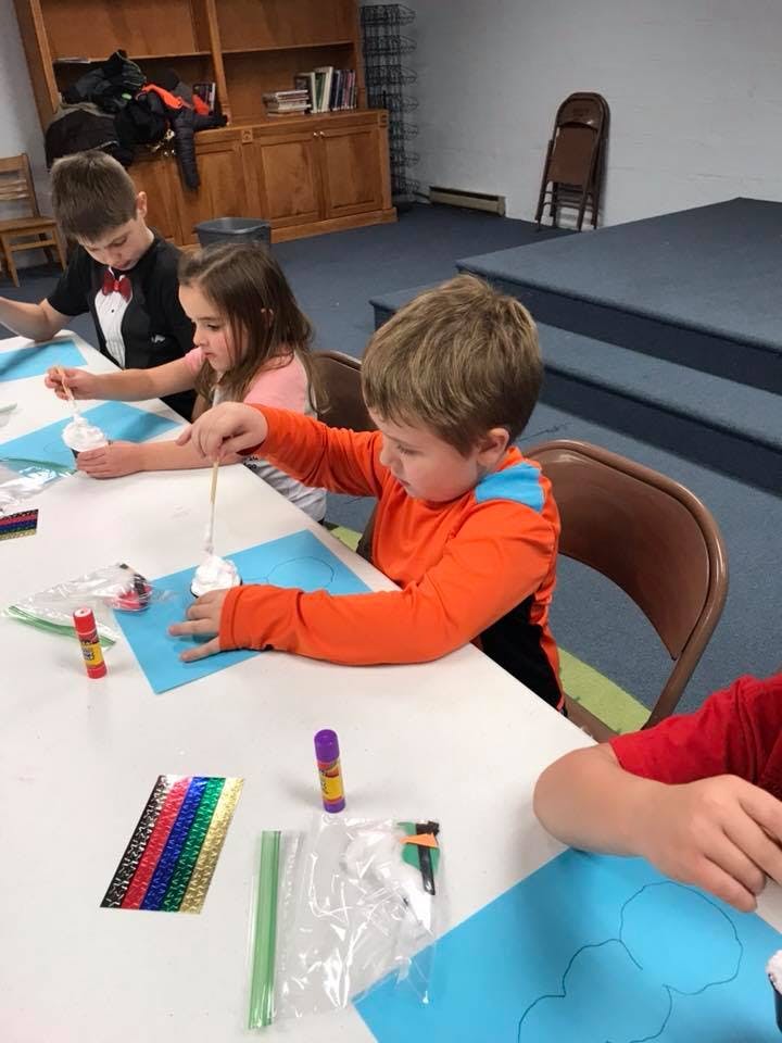 Children doing crafts at a table
