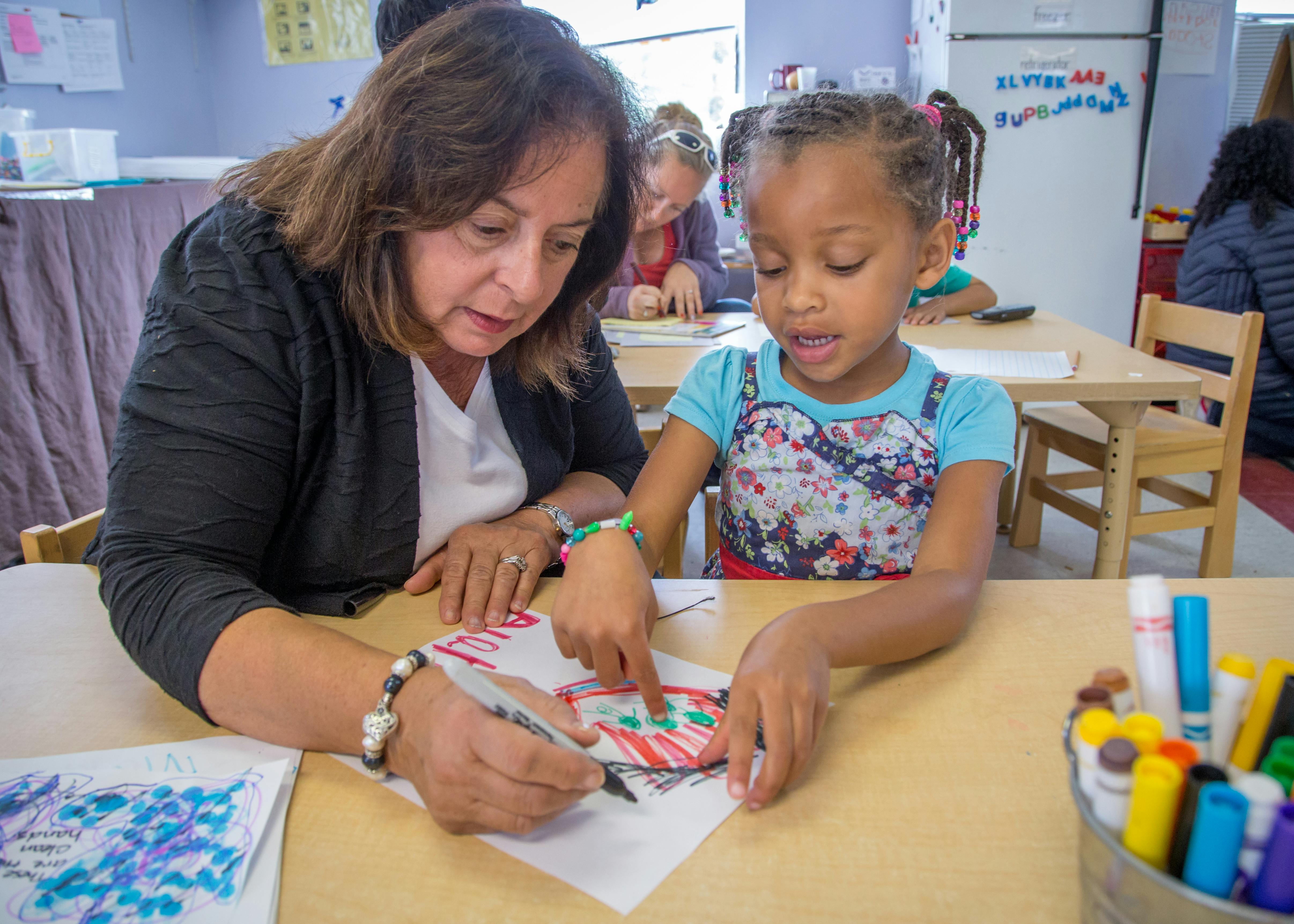 Adult and child drawing together at a table