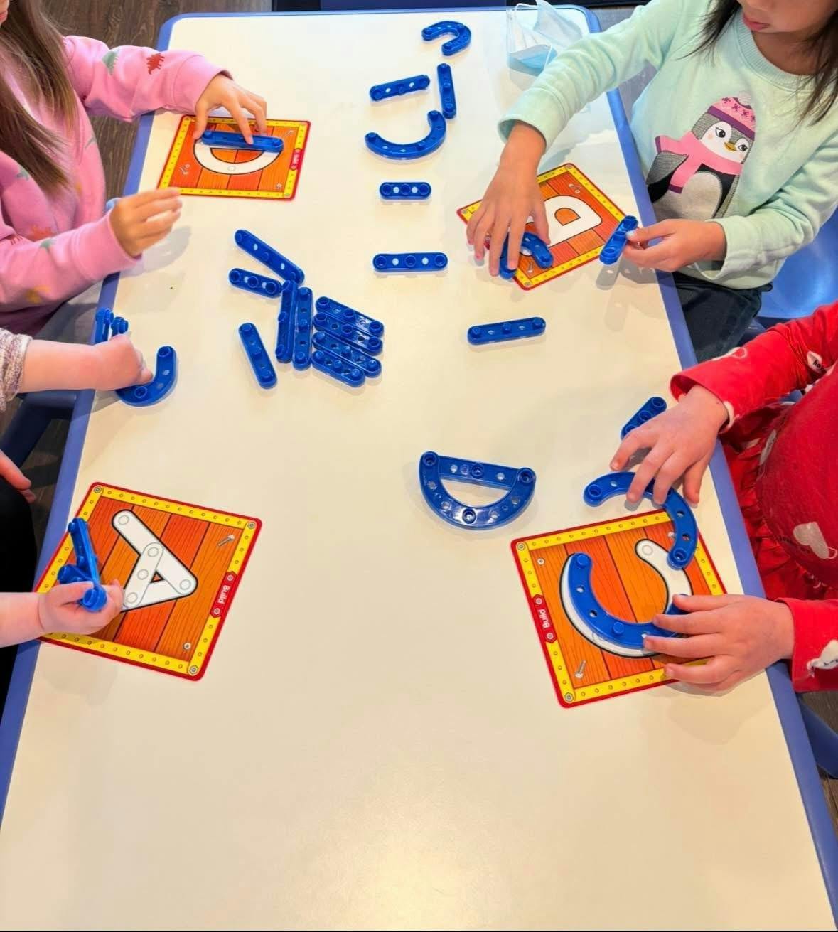 Children learning with alphabet building toys