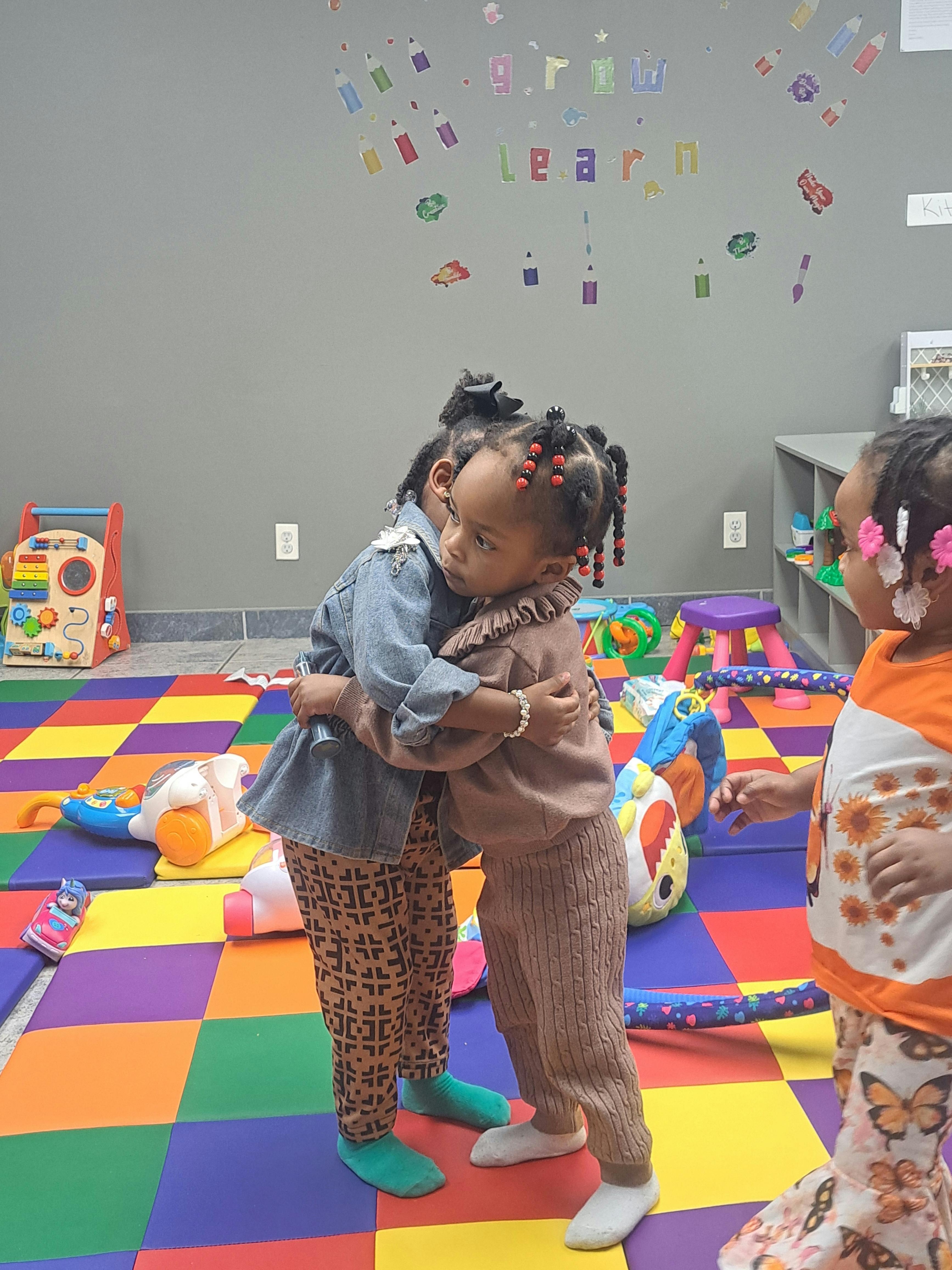 Two children hugging in a classroom