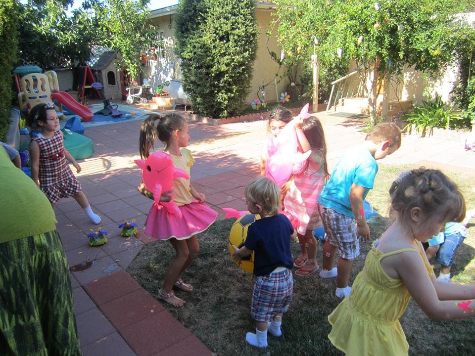 Children playing outdoors with toys