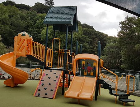 Playground with slides, climbing wall, and covered structure