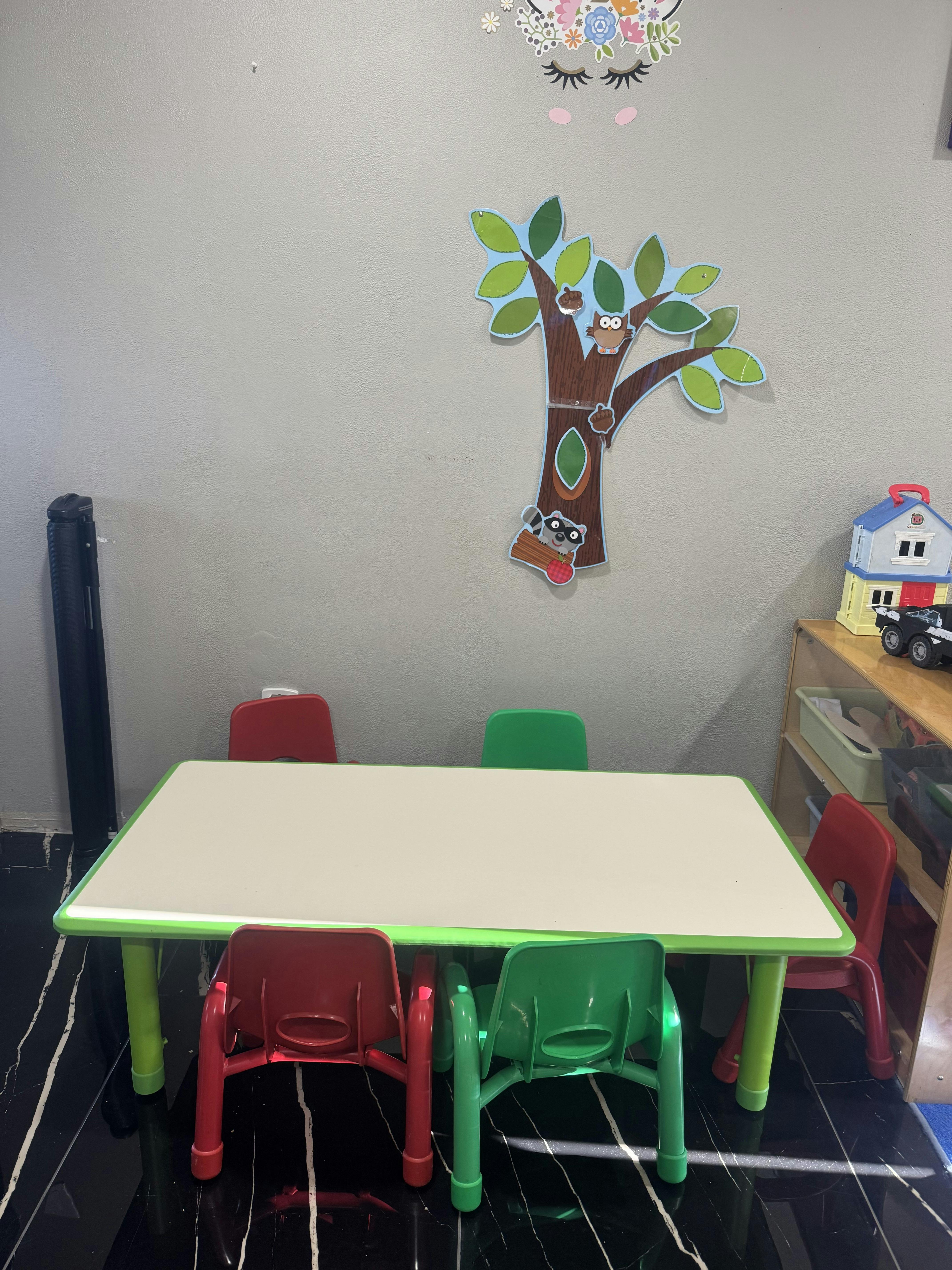 Small table with four children's chairs, two red and two green