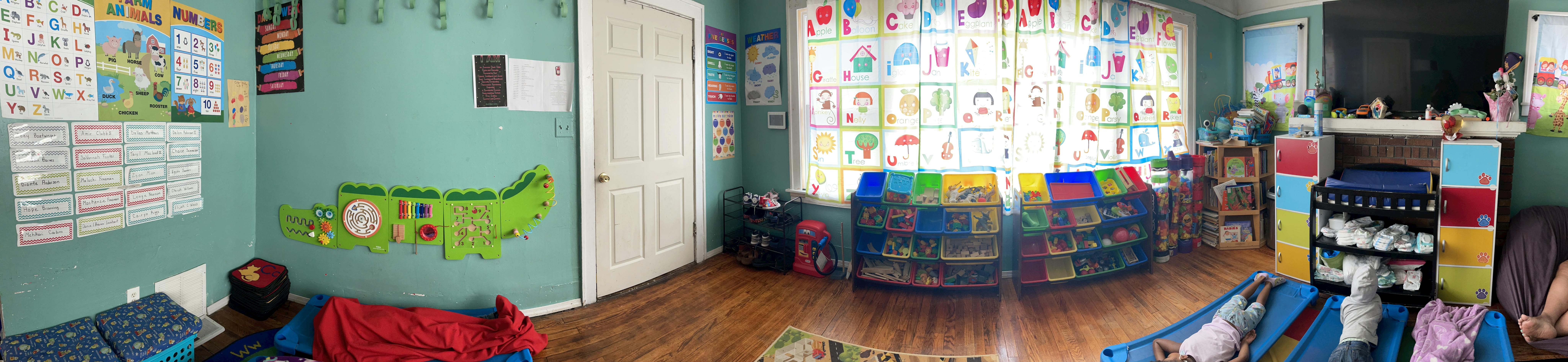 A colorful classroom with posters on the wall and storage bins